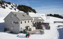 Berghütte mit Sonnenterasse voller Menschen  | © Bergbahnen Flumserberg AG