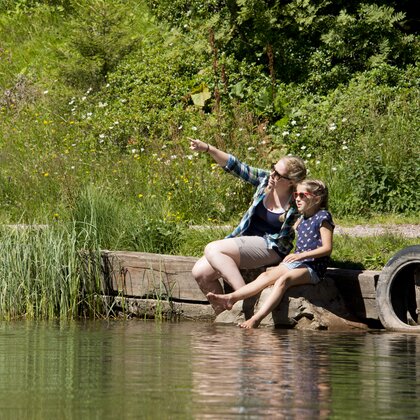 Frau und Mädchen machen eine Pause beim Seebensee am Flumserberg | © Bergbahnen Flumserberg AG Eine Frau und ein Mädchen sitzen gemeinsam an einem See und schauen in die Ferne | © Bergbahnen Flumserberg AG