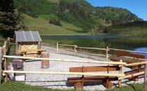 Feuerstelle mit Sitzbänken an einem See mit Bergpanorama | © Bergbahnen Flumserberg AG